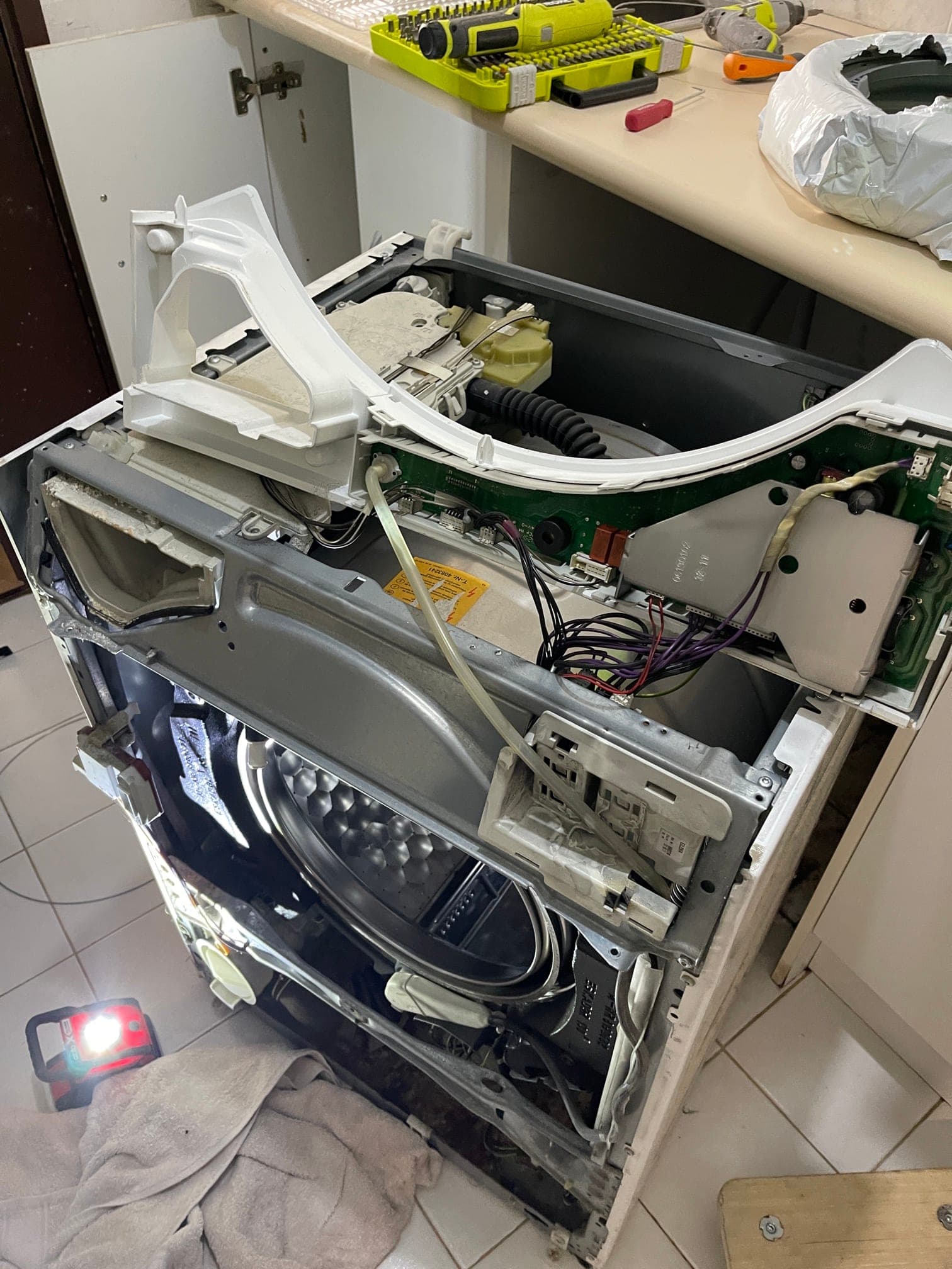 A dishwasher door seal being replaced.